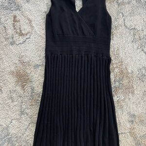 Black knit pleated dress with ribbed waistline and keyhole back